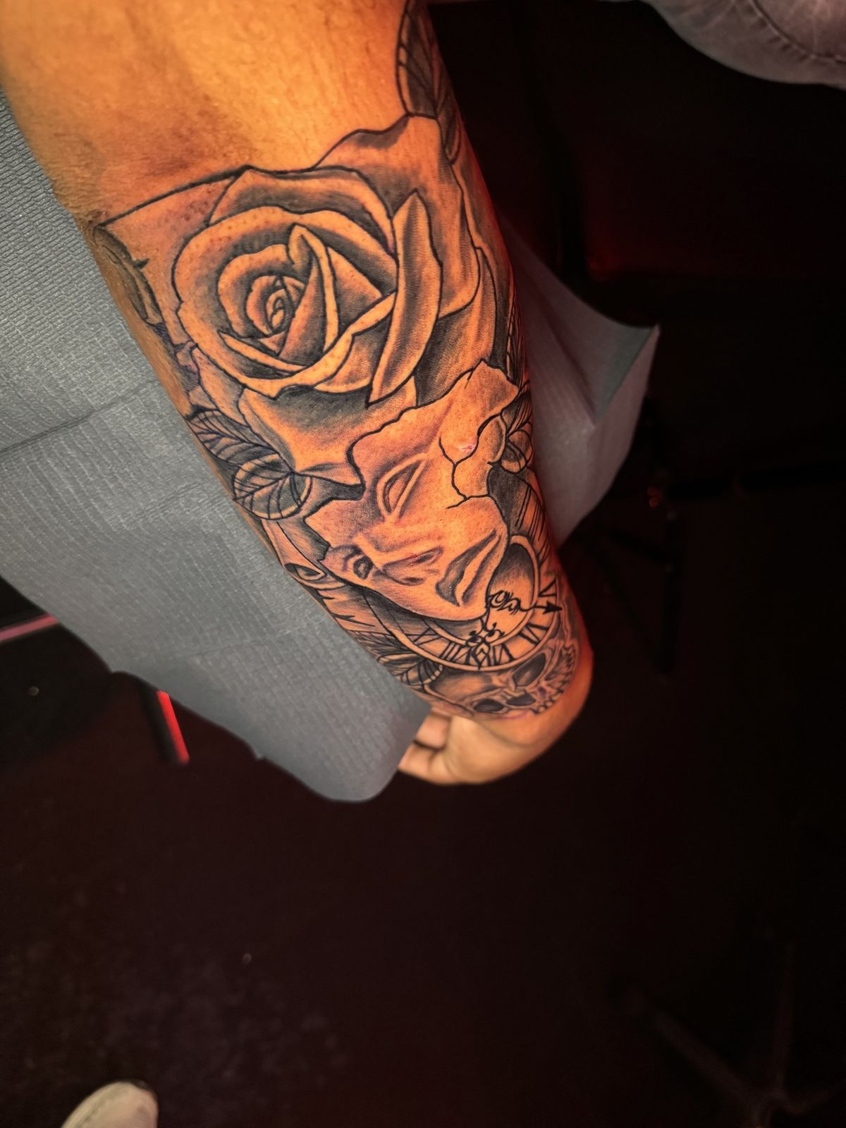 Black and grey rose with woman portrait and clock, forearm piece