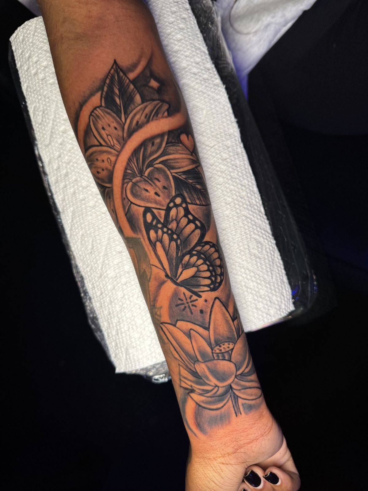 Black and grey butterfly with lotus, forearm tattoo