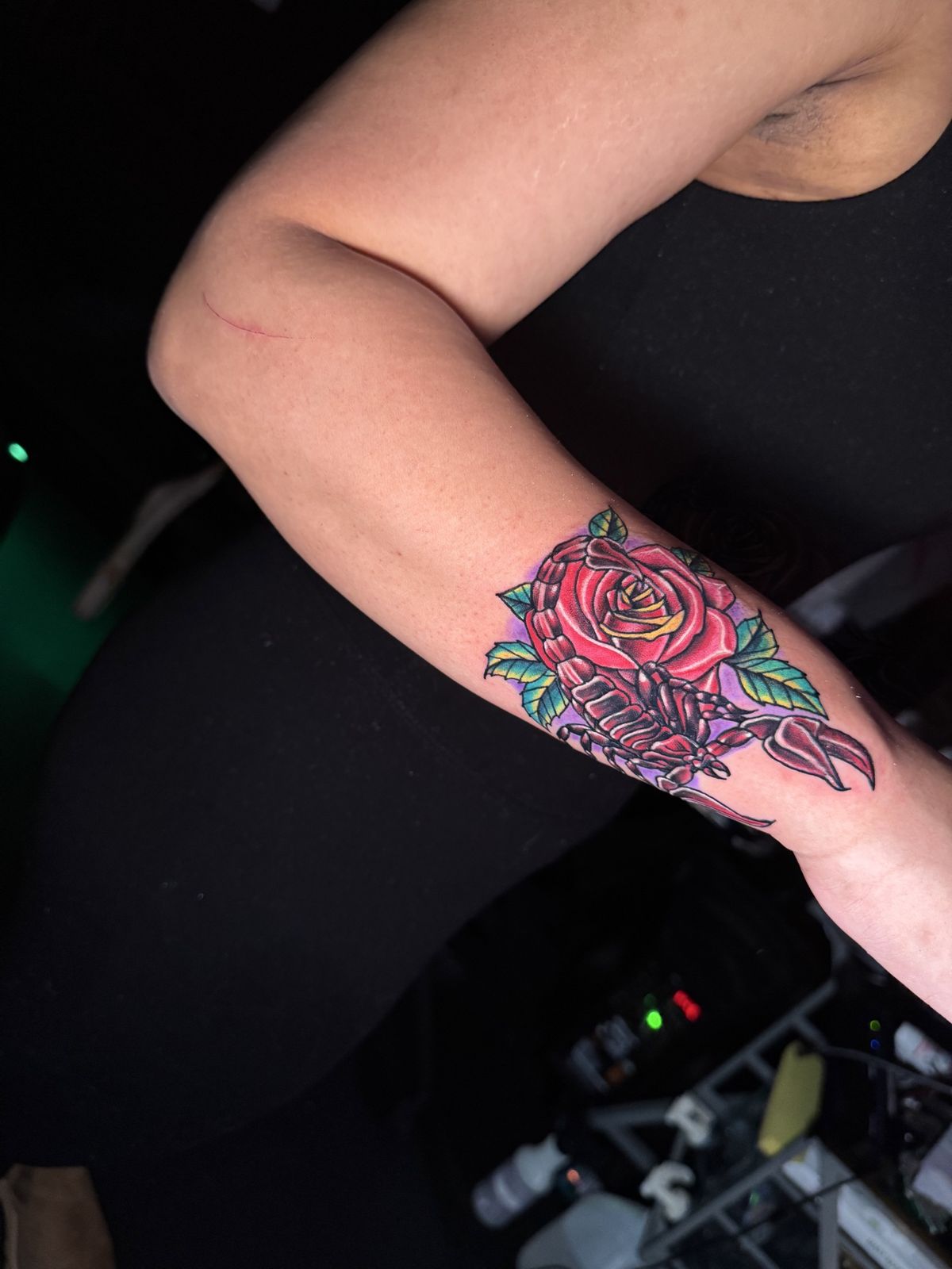 Red rose and scorpion forearm tattoo