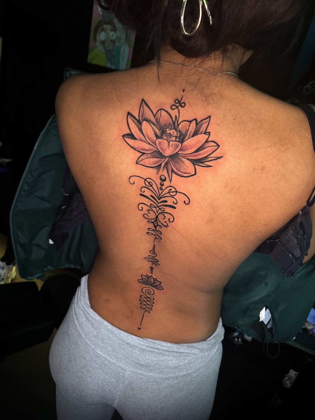 Lotus back piece with ornamental spine linework